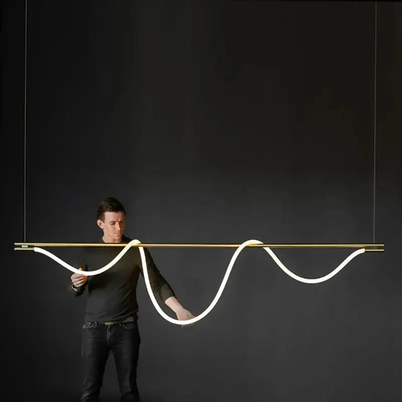 Modern gold curved LED chandelier pendant with sinuous white LED ribbon over bar on Tampa Home & Garden Store