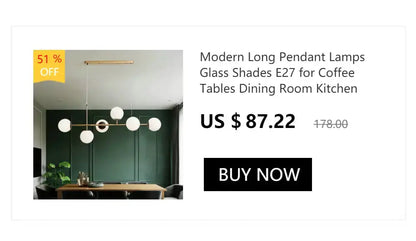 Decorbites modern gold curved pendant chandelier with glass globe lights over dining table on Tampa Home & Garden Store