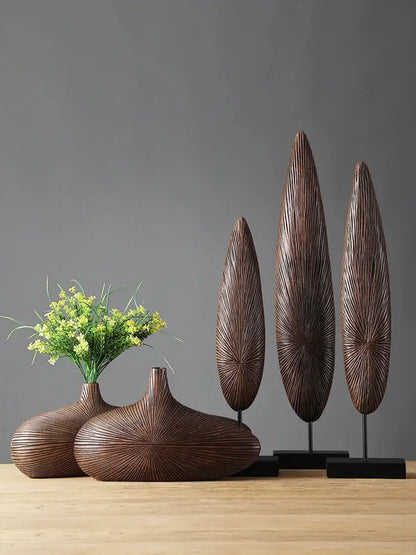 Light brown resin vase set with 2 wide rounded vases and 3 tall oval sculptures on bases on Tampa Home & Garden Store