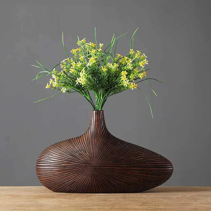 Light brown resin vase by Decorbites with a ribbed bulbous base and slim neck and flowers on Tampa Home & Garden Store