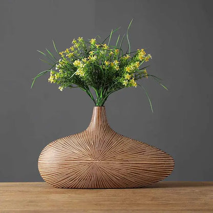 Light brown resin vase with radiant lines by Decorbites, vase showcases yellow blooms on Tampa Home & Garden Store