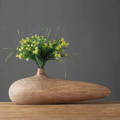 Light brown resin vase by Decorbites with teardrop form and texture yellow florals on Tampa Home & Garden Store