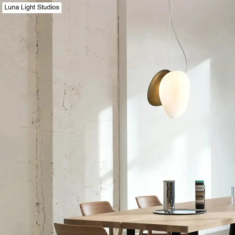 Modern cream white glass stacked pendant light with brass backplate over dining table on Tampa Home & Garden Store