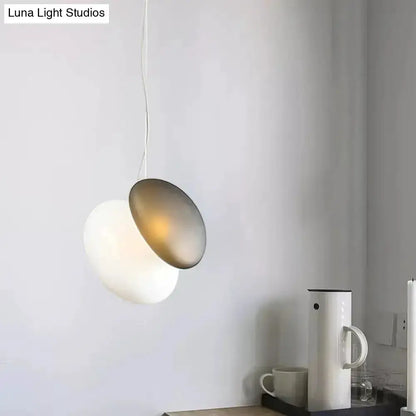 Modern cream white glass stacked pendant light for dining with overlapping discs and warm glow on Tampa Home & Garden Store
