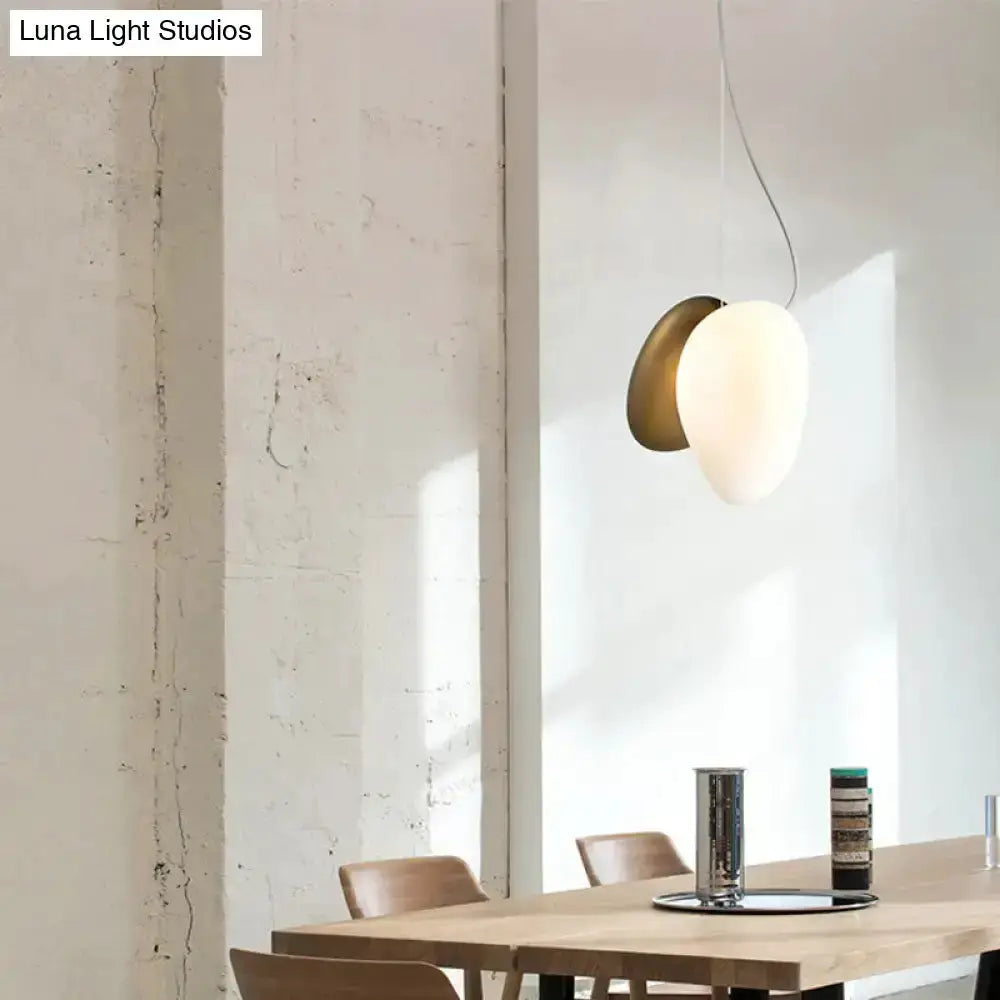 Modern cream white glass stacked pendant light Decorbites with brass backplate over dining table on Tampa Home & Garden Store