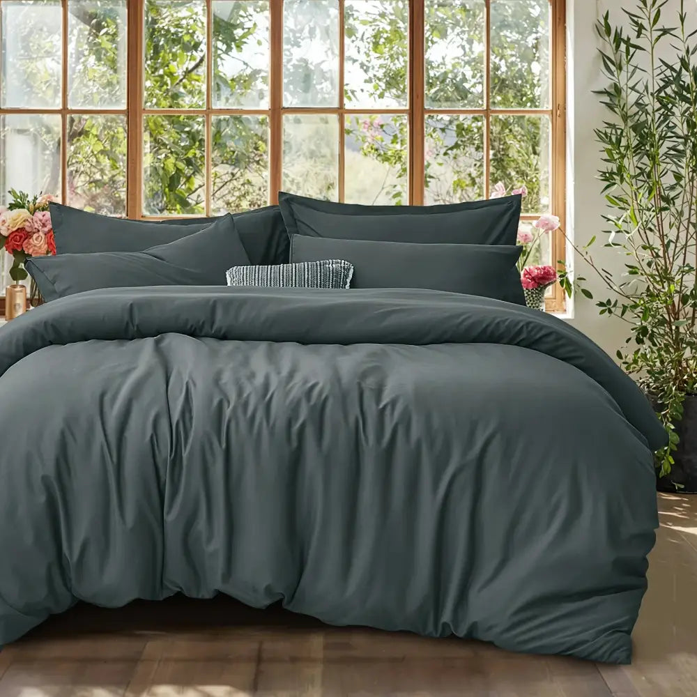 Black Satin Duvet Set by Decorbites on a bed with matching dark shams in a sunlit room on Tampa Home & Garden Store