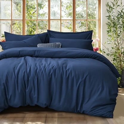 Black satin duvet set by Decorbites on a bed with matching navy pillow shams on Tampa Home & Garden Store