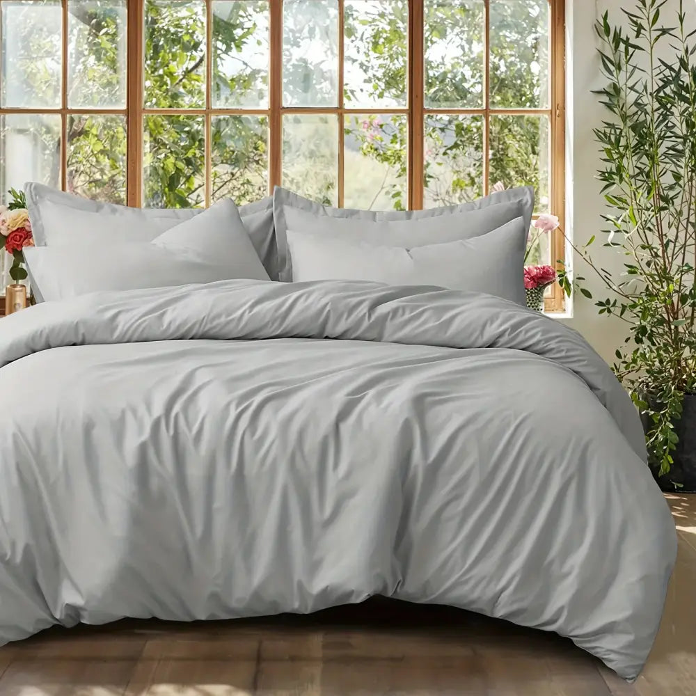 Decorbites black satin duvet set on bed with gray pillows and smooth comforter on Tampa Home & Garden Store