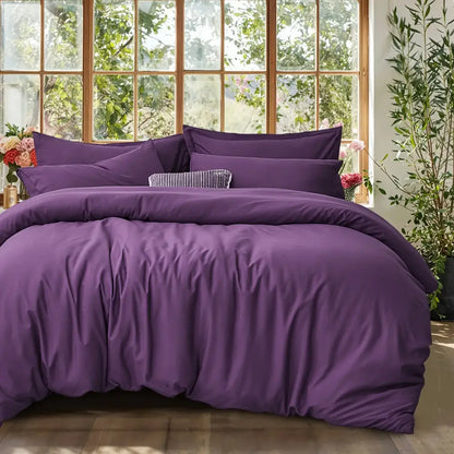 Black satin duvet set by Decorbites with matching pillow shams on a bed in a bright room on Tampa Home & Garden Store