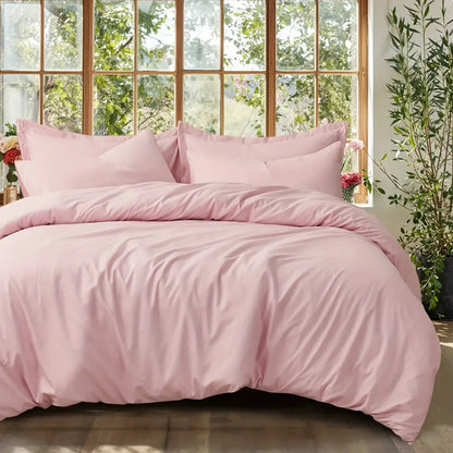 Pink satin duvet set with matching pillow shams on a bed by Decorbites on Tampa Home & Garden Store