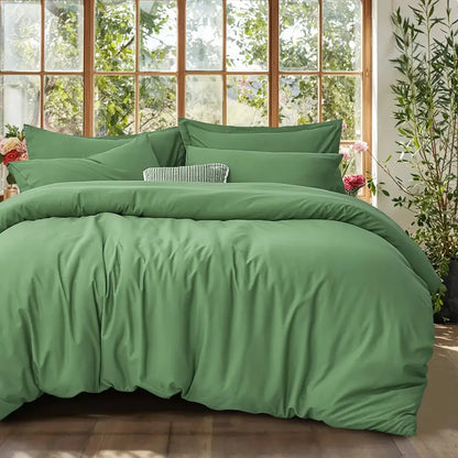 Decorbites green satin duvet set on bed with matching pillows in a room with large windows on Tampa Home & Garden Store