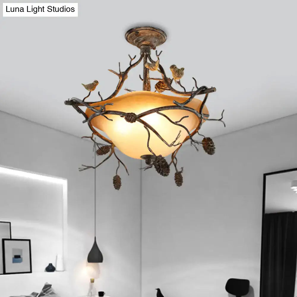 Bronze Bird Branch Light ceiling fixture with amber glass shade and pinecone accents on Tampa Home & Garden Store