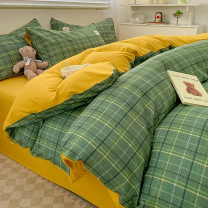 Nordic plaid muted green duvet cover by Decorbites with yellow reverse on a bed on Tampa Home & Garden Store