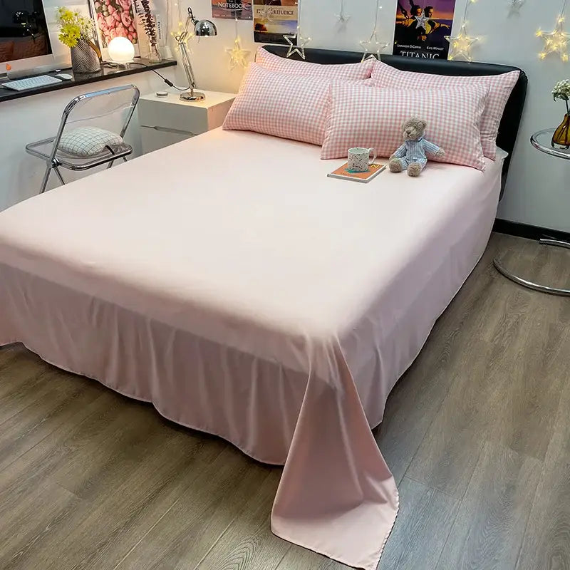 Duvet cover set pink with two gingham pillows on a neat bed in a cozy bedroom Decorbites on Tampa Home & Garden Store