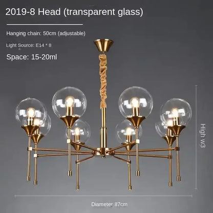 Modern brass chandelier with eight smoked glass globes and brass arms by Decorbites on Tampa Home & Garden Store