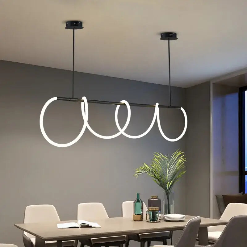Gold Nordic Ceiling Chandelier by Decorbites with glowing looping rings on a dark metal bar on Tampa Home & Garden Store