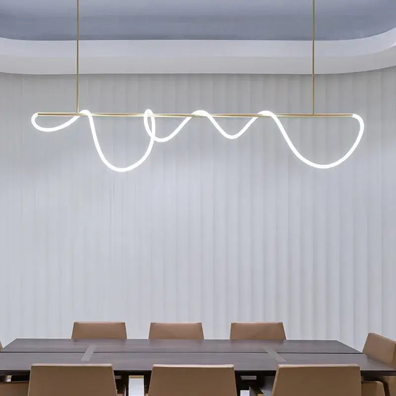 Gold Nordic Ceiling Chandelier by Decorbites with a gold bar and wave LED tubing over a dining table on Tampa Home & Garden Store
