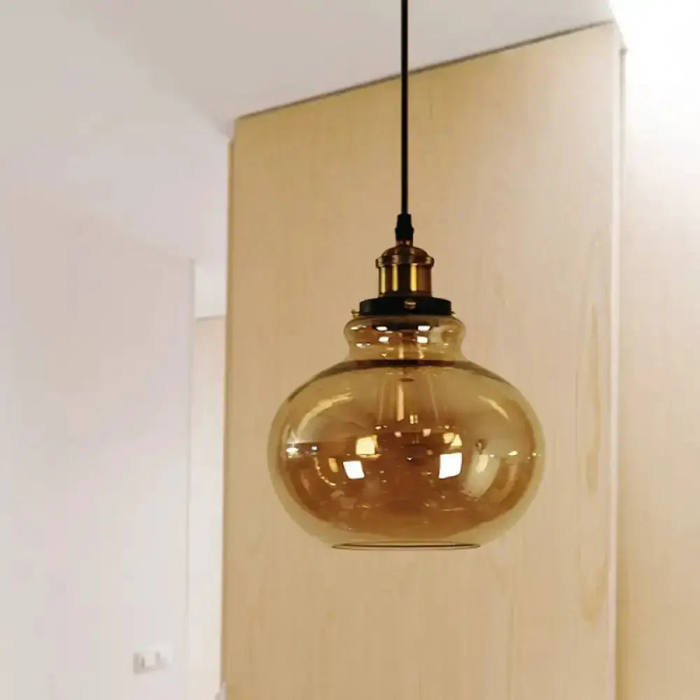 Farmhouse brass pendant with amber glass globe hanging light on black cord on Tampa Home & Garden Store