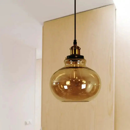 Farmhouse brass pendant with amber glass globe hanging light on black cord on Tampa Home & Garden Store