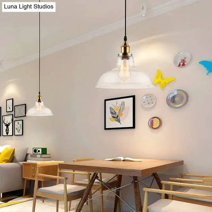Farmhouse brass clear glass pendant lights pair over a wooden dining table on Tampa Home & Garden Store