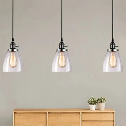 Farmhouse black 3-light clear glass pendant lights with metal hardware over a sideboard on Tampa Home & Garden Store