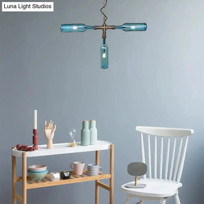 Farmhouse bottle chandelier smoke gray blue with aged silver hardware above a white dining setup on Tampa Home & Garden Store