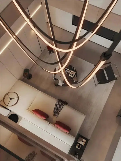 Chandelier Decorbites leather belt LED chandelier with looping warm LEDs over a white sofa on Tampa Home & Garden Store