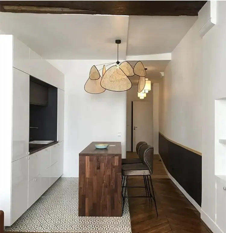 Chandelier Decorbites French design natural tan rattan pendant light over a wooden island on Tampa Home & Garden Store