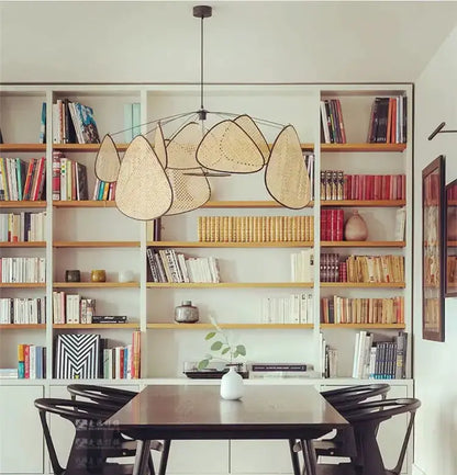 Chandelier Decorbites tan rattan pendant light with woven leaf shades over a dining table on Tampa Home & Garden Store