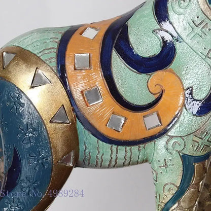 Teal and gold giraffe mother sculpture by Decorbites with orange bands and silver accents on Tampa Home & Garden Store