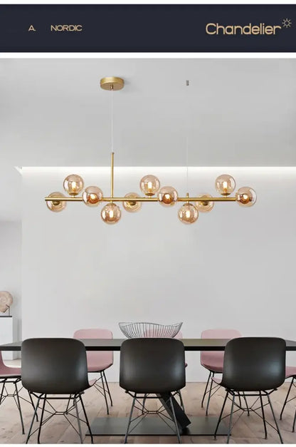 Black Amber Glass Chandelier with a gold metal frame and amber glass globes over a dining table on Tampa Home & Garden Store