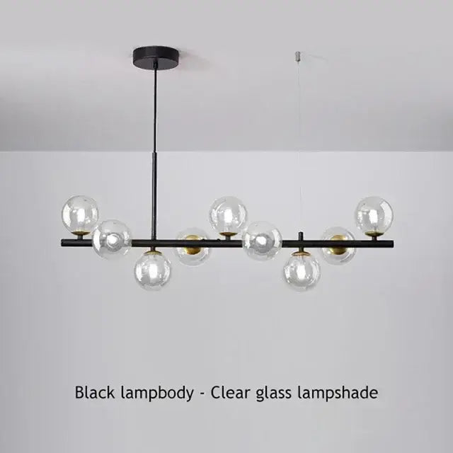Gold Glass Ball Chandelier with black lampbody and clear glass globes on a linear bar on Tampa Home & Garden Store