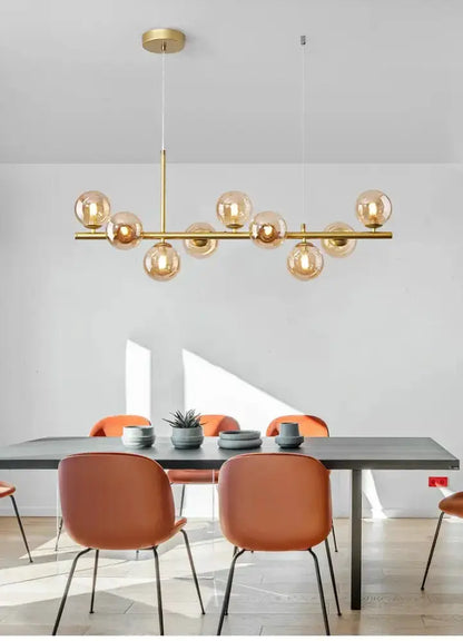 Chandelier Modern gold glass ball pendant light over dining table with cognac chairs on Tampa Home & Garden Store