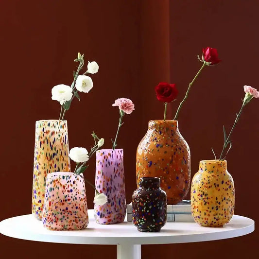 Colorful speckled glass vases in assorted sizes with flowers for living room decor on Tampa Home & Garden Store