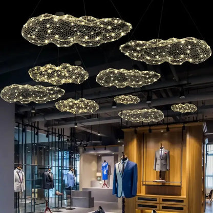 Modern gold mesh cloud pendant lights chandelier with LED glow, cloud-shaped fixtures in showroom on Tampa Home & Garden Store
