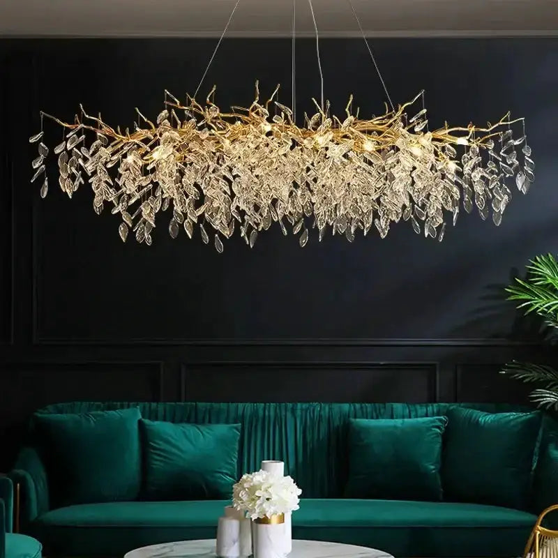 Chandelier modern gold crystal LED branch with hanging crystal leaves over teal sofa on Tampa Home & Garden Store