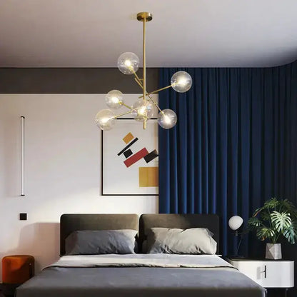 Chandelier Decorbites gold glass bubble starburst over a gray bed in a room with navy curtains on Tampa Home & Garden Store