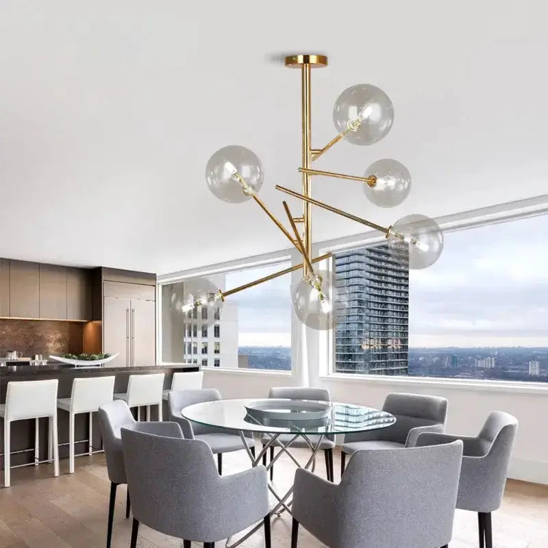 Chandelier gold glass bubble starburst with clear globes over round glass table on Tampa Home & Garden Store