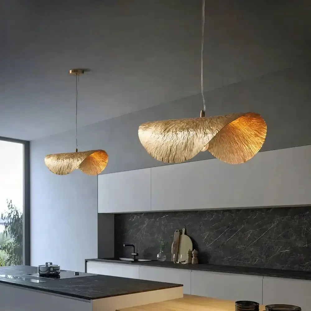 Modern gold lotus leaf pendant lights pair over kitchen island on Tampa Home & Garden Store