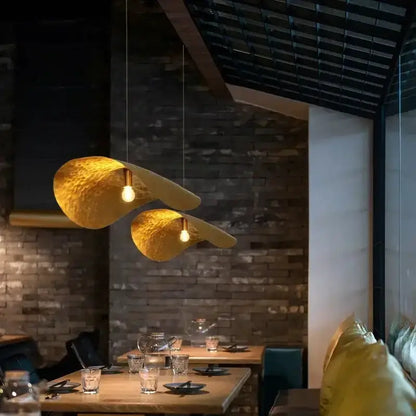 Modern gold lotus leaf pendant lights by Decorbites, twin hammered shades over dining table on Tampa Home & Garden Store