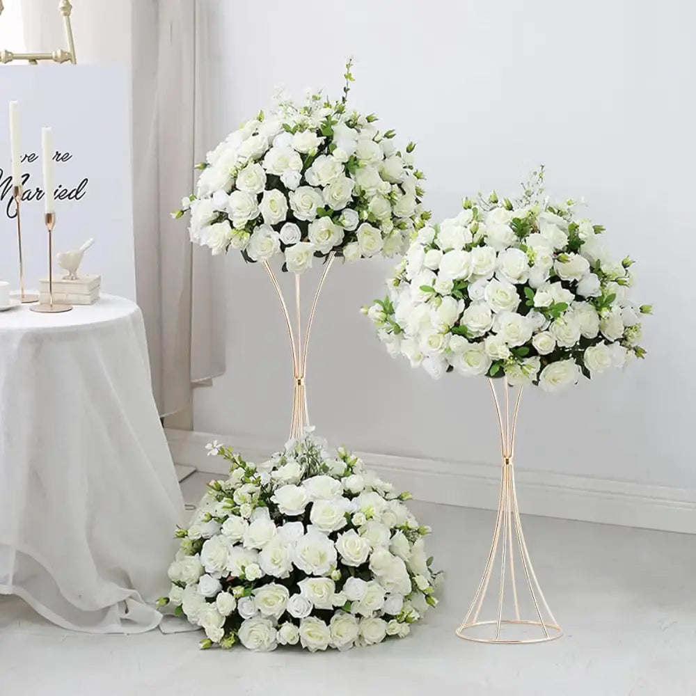 Two gold trumpet vase stands with lush white rose arrangements by Decorbites on Tampa Home & Garden Store