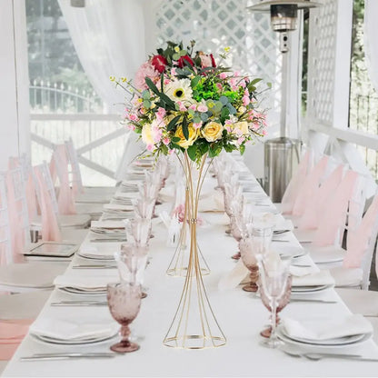 Gold trumpet vase stand by Decorbites with pastel floral arrangement on a white banquet table on Tampa Home & Garden Store