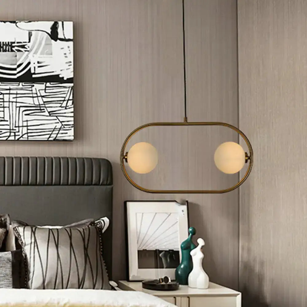 Gold Globe Hanging Chandelier with a gold oval frame and two frosted glass globes on Tampa Home & Garden Store
