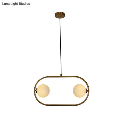 Gold Globe Hanging Chandelier with brass oval frame and two frosted glass globes on Tampa Home & Garden Store