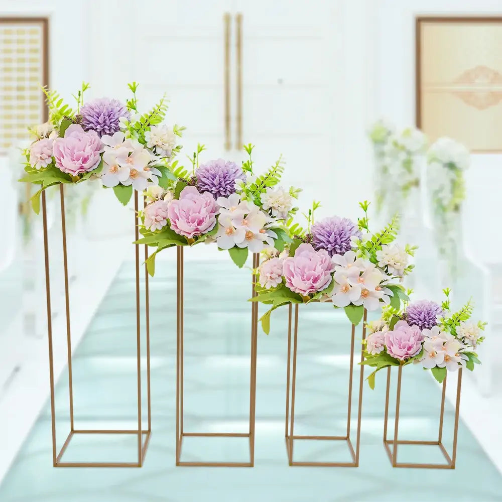 Decorbites gold wedding vase stands with pink and lavender blossoms on four gold frames on Tampa Home & Garden Store