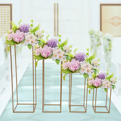 Decorbites gold wedding vase stands with pink and lavender blossoms on four gold frames on Tampa Home & Garden Store