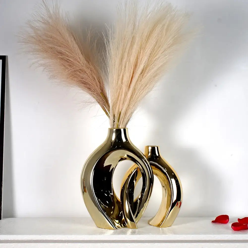 Golden ceramic vases, two ring-cut mirror-gold pieces by Decorbites with pampas grass on Tampa Home & Garden Store