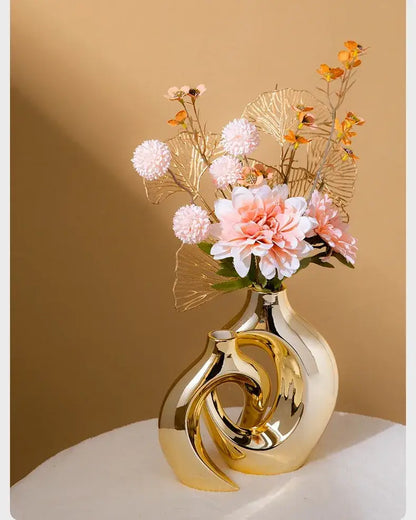 Golden Ceramic Flower Vase by Decorbites; sculptural gold loop design with pink bouquet on Tampa Home & Garden Store