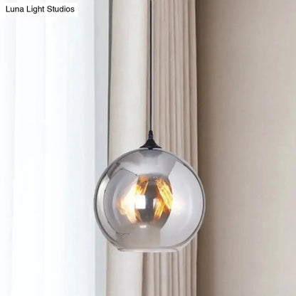 Decorbites industrial grey glass spherical pendant light with black cord and warm filament bulb on Tampa Home & Garden Store