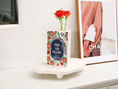 Navy ceramic book vase with red roses, Decorbites, book-shaped vase on a white pedestal on Tampa Home & Garden Store